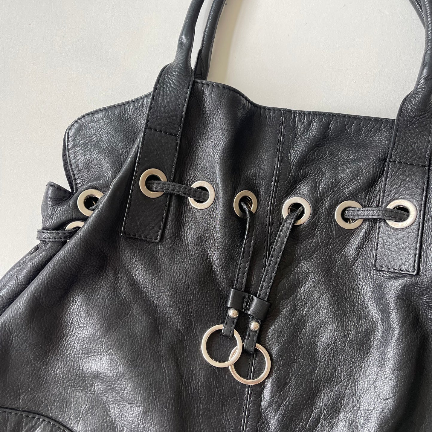 Black grommet slouchy bag