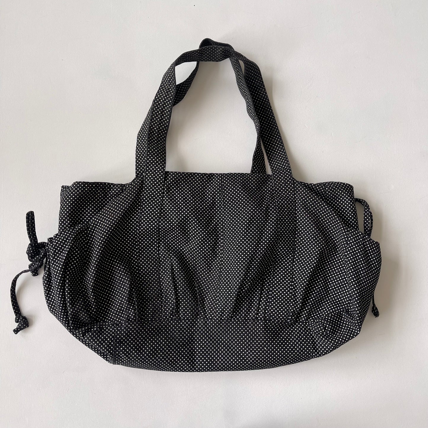 Black drawstring polka dot bag