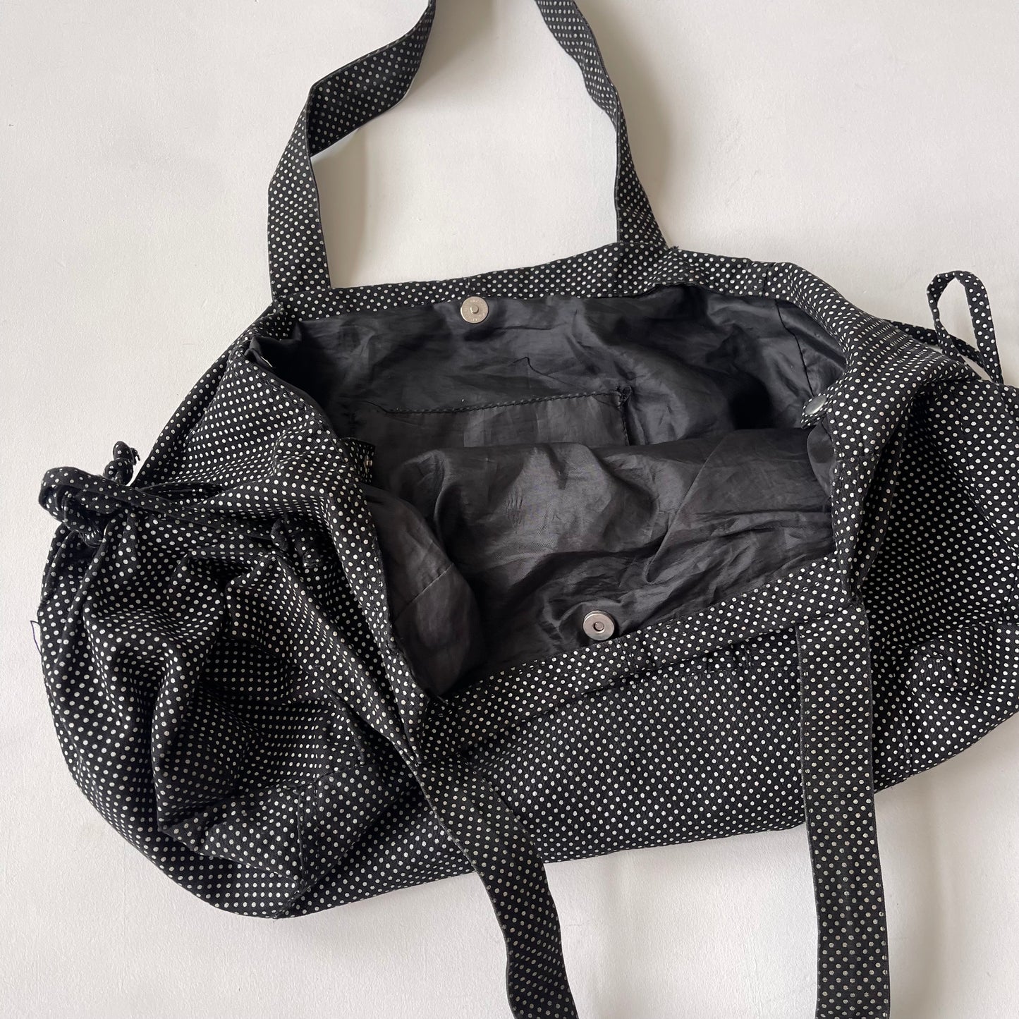 Black drawstring polka dot bag