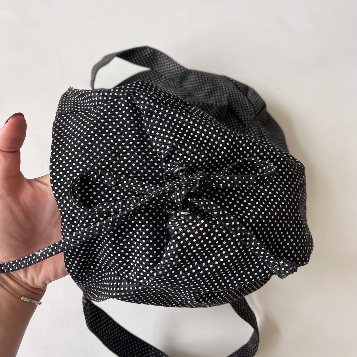 Black drawstring polka dot bag