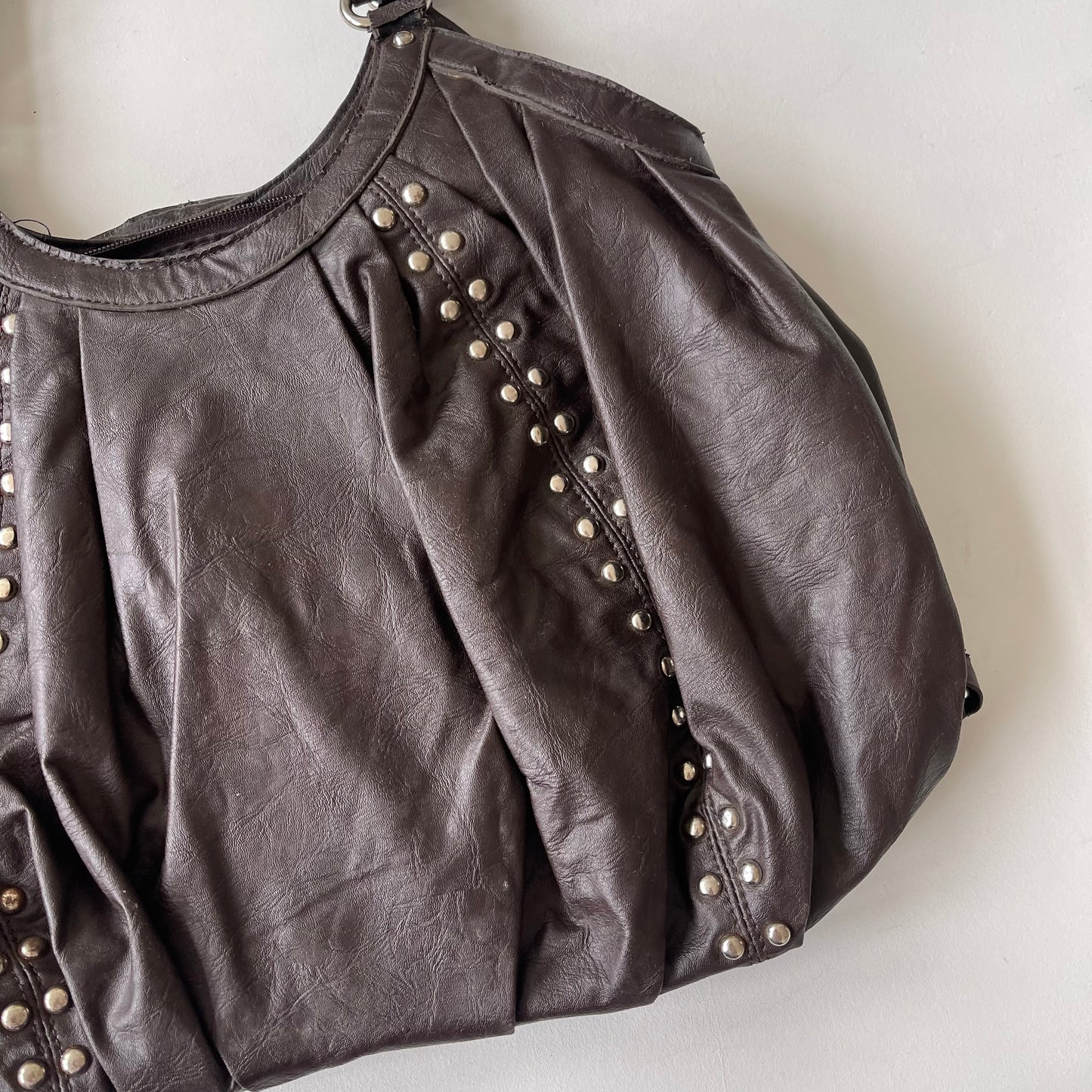 Brown studded slouchy bag